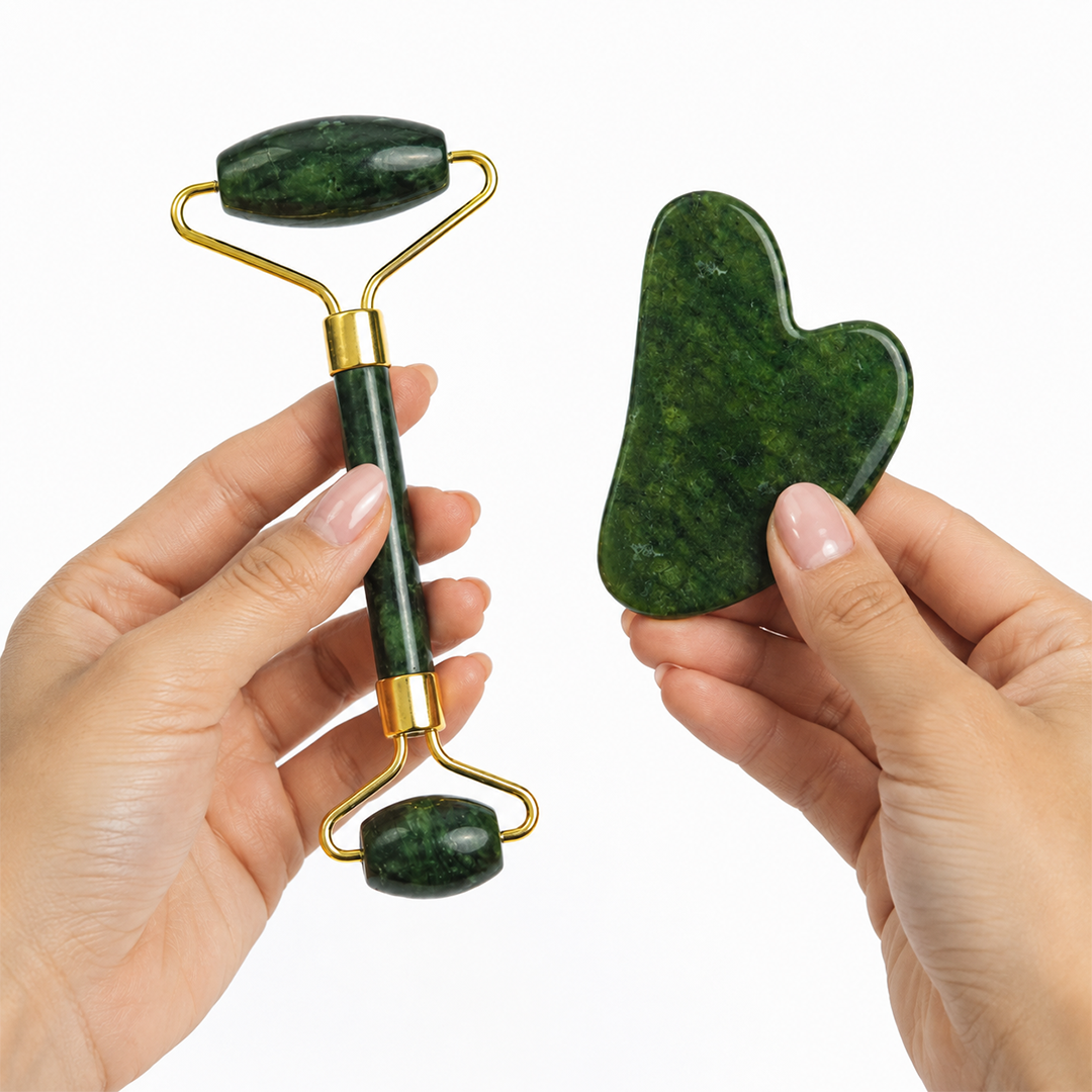 Hands holding the jade facial roller and gua sha stone, showing their size